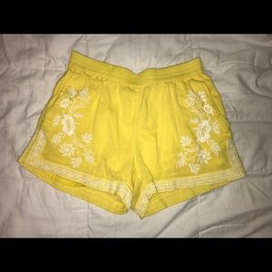 yellow shorts w/ embroidered flower pattern